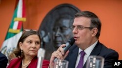 Mexican Foreign Affairs Secretary Marcelo Ebrard, right, accompanied by Mexican Ambassador to the U.S. Martha Barcena, speaks during a news conference at the Mexican Embassy in Washington, June 3, 2019.