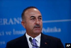 FILE - Turkey's Foreign Minister Mevlut Cavusoglu, listens to a reporter's question during a joint news conference with Russia's Foreign Minister Sergey Lavrov (not pictured), in Ankara, Turkey, Aug. 14, 2018.