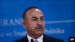 FILE - Turkey's Foreign Minister Mevlut Cavusoglu, listens to a reporter's question during a joint news conference with Russia's Foreign Minister Sergey Lavrov (not pictured), in Ankara, Turkey, Aug. 14, 2018.