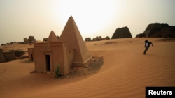 FILE - A boy plays near the site of 44 Nubian pyramids of kings and queens in the ruins of the ancient city of Meroe at Begrawiya, near Shendi in the River Nile state of Sudan March 10, 2012. (REUTERS/ Mohamed Nureldin Abdallah)