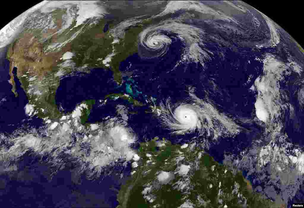 Hurricane Maria which bore down menacingly on the Virgin Islands and Puerto Rico on Tuesday after devastating the tiny island nation of Dominica and Hurricane Jose (top) are both seen in the Atlantic Ocean in this NOAA's GOES East satellite image taken at