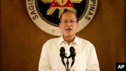 FILE - Philippine President Benigno Aquino III addresses the nation in a live broadcast from the Presidential Palace in Manila. Aquino says Philippine aircraft will continue to fly their usual routes over disputed reefs in the South China Sea.