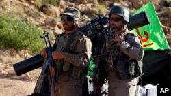 Hezbollah fighters stand on their army vehicle at the site where clashes erupted between Hezbollah and al-Qaida-linked fighters in Wadi al-Kheil or al-Kheil Valley in the Lebanon-Syria border, July 29, 2017. When President Trump praised the Lebanese government for fighting Hezbollah last week, the Iranian-backed group was busy demonstrating just how wrong he was, clearing the country's eastern frontier from al-Qaida and negotiating a complex prisoners swap with the militant group alongside the Lebanese government.