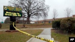 Crime scene tape is used around Great Mills High School, the scene of a shooting, March 20, 2018, in Great Mills. A student with a handgun shot two classmates inside the school before he was fatally wounded during a confrontation with a school resource of