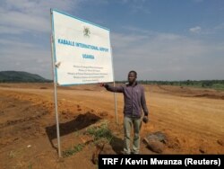 Christop Opiyo point at where his house used to be in Kabaale village before they were evicted for the construction of an airport in Hoima District, Uganda, July 14, 2018.