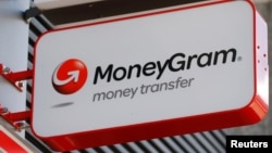 FILE - A Moneygram logo is seen outside a bank in Vienna, Austria, June 28, 2016. 