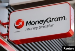 FILE - A Moneygram logo is seen outside a bank in Vienna, Austria, June 28, 2016.