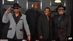FILE - Dennis D.T. Thomas, from left, George Brown, Robert Bell, and Ronald Bell, of the musical group Kool & The Gang, arrive at the 59th annual Grammy Awards at the Staples Center, in Los Angeles, Feb. 12, 2017.