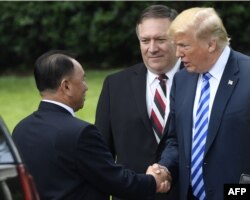 President Donald Trump, accompanied by U.S. Secretary of State Mike Pompeo, says goodbye to North Korea's Kim Yong Chol after their meeting at the White House, June 1, 2018, in Washington.