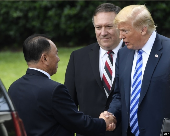 President Donald Trump, accompanied by U.S. Secretary of State Mike Pompeo, says goodbye to North Korea's Kim Yong Chol after their meeting at the White House, June 1, 2018, in Washington.
