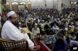 FILE - Pakistani cleric Hafiz Saeed, the founder of the outlawed Lashkar-e-Taiba group, which was blamed for the 2008 Mumbai attacks that killed 166 people, addresses at a mosque in Lahore, Pakistan, Nov. 1, 2018.
