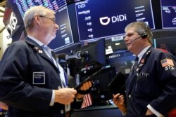 Traders work during the IPO for Chinese ride-hailing company Didi Global Inc on the New York Stock Exchange (NYSE) floor in New York City, U.S., June 30, 2021.