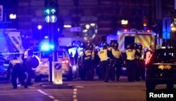 FILE - Police attend to an incident on London Bridge in London, Britain, June 3, 2017.