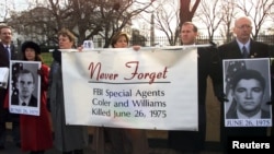 FBI Agents hold a banner in front of the White House during an FBI rally, December 15, 2000. The rally was held to show opposition to any consideration by then-President Bill Clinton to grant clemency to Leonard Peltier, convicted of murdering two FBI age