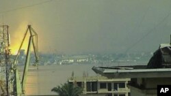 This video image taken across the Congo river in Kinshasa, Congo, shows a blast that rocked Brazzaville the capital of the Republic of Congo, March 4, 2012. 