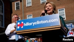 Democratic presidential candidate Hillary Clinton takes the stage for a rally with Virginia Governor Terry McAuliffe in Alexandria, Virginia, Oct. 23, 2015.