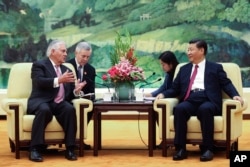 U.S. Secretary of State Rex Tillerson, left, meets with China's President Xi Jinping at the Great Hall of the People, Saturday, Sept. 30, 2017, in Beijing.
