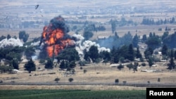 An explosion is seen at Quneitra at the Syrian side of the Israeli Syrian border as it is seen from the Israeli-occupied Golan Heights, Israel, July 22, 2018. 