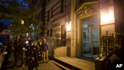 Media gather outside the home of Craig Spencer, a Doctors Without Borders physician who recently returned to the city after treating Ebola patients in West Africa, Thursday, Oct. 23, 2014.