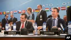 FILE - NATO Secretary-General Anders Fogh, right, and Georgian Defense Minister Irakli Alasania take their seat at a meeting of the NATO-Georgia Commission at NATO headquarters in Brussels, Belgium. 