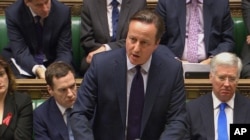 British Prime Minister David Cameron talks to lawmakers inside the House of Commons in London during a debate on launching airstrikes against Islamic State extremists inside Syria, Dec. 2, 2015.
