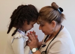 This undated photo shows Katherine Ramos, right, with her 4-year-old daughter Victoria Ramos at their home in Patterson, N.Y. Ramos is one of an army of health care workers that heeded New York's call for help.