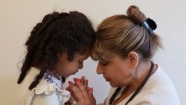 This undated photo shows Katherine Ramos, right, with her 4-year-old daughter Victoria Ramos at their home in Patterson, N.Y. Ramos is one of an army of health care workers that heeded New York's call for help.