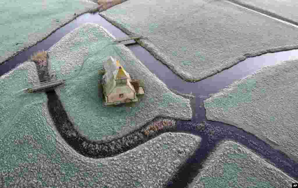 A view of St. Thomas Becket church during the morning frost, in Fairfield, Kent, England, following freezing overnight temperatures.