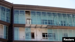 A rocket-propelled grenade damaged Libyan government offices in Tripoli June 4, 2014.