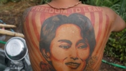 A member of the PDF shows off his tattoo of Aung San Suu Kyi