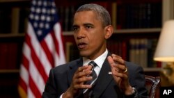 FILE - President Barack Obama speaks during an interview at the White House.