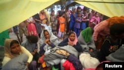 Rohingya refugees, who were on a boat traveling from Myanmar that capsized at Bailakhali beach, wait to transported to a refugee camp from the beach, near Cox's Bazar, Bangladesh, Oct. 31, 2017.