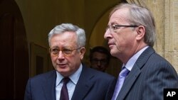 Luxembourg's Prime Minister and the chairman of the Eurogroup meetings of eurozone nations, Jean Claude Juncker, right, and Italy's Finance Minister Giulio Tremonti leave Juncker's office after a meeting in Luxembourg, Aug. 3, 2011