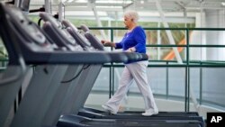 FILE - A woman, who suffers from diabetes, is seen walking on a treadmill as part of an exercise program to help control the disease.