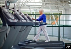 FILE - A woman who suffers from diabetes is seen walking on a treadmill as part of an exercise program to help control the disease.