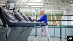 FILE - A woman, who suffers from diabetes, is seen walking on a treadmill as part of an exercise program to help control the disease.