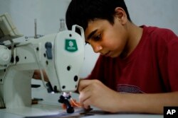 Syrian refugee child, Ahmad Abo Baker works at a shoe workshop in Gaziantep, southeastern Turkey, June 2, 2016.