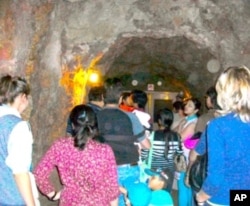 Tourists head toward the cave door at Glenwood Caverns.