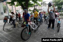Winners of the Benjamin Canlas Courage to be Kind Foundation get their bicycles in the financial district of Manila, Philippines, July 11, 2020.