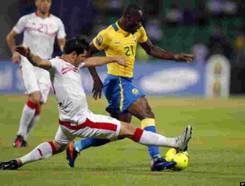 Gabon's Roguy Meye (R) challenges Khalil Chammem of Tunisia during their African Cup of Nations Group C soccer match at Franceville stadium in Gabon January 31, 2012.
