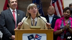 FILE - Dr. Candace S. Johnson, president and CEO of Roswell Park Cancer Institute, announces the signing of an agreement to test a Cuban lung cancer treatment in the U.S., before the New York delegation leaves the Jose Marti International Airport in Havana, Cuba, April 21, 2015.