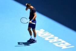 Novak Djokovic of Serbia wipes the sweat from his brow during a practice session ahead of the Australian Open at the Melbourne Park tennis centre in Melbourne on January 12, 2022. (Photo by William WEST / AFP)