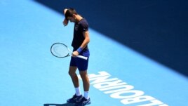Novak Djokovic of Serbia wipes the sweat from his brow during a practice session ahead of the Australian Open at the Melbourne Park tennis centre in Melbourne on January 12, 2022. (Photo by William WEST / AFP)