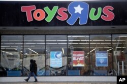 A person walks near the entrance to a Toys R Us store, Jan. 24, 2018, in Wayne, New Jersey.