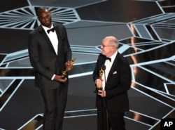 Kobe Bryant, left, and Glen Keane accept the award for best animated short for "Dear Basketball" at the Oscars on Sunday, March 4, 2018, at the Dolby Theatre in Los Angeles. (Photo by Chris Pizzello/Invision/AP)