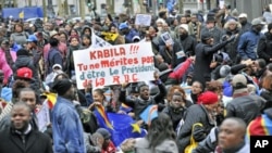 Supporters of Congo's opposition hold reading 'Kabila !!! you do not deserve DRC's Presidency' during a demonstration against what many say were deeply flawed November elections, in downtown Antwerp, DRC, December 2011. (file photo)