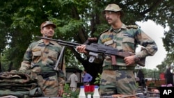 Indian army soldiers display seized arms and ammunition at the army headquarters in Srinagar, India, August 16, 2013. 