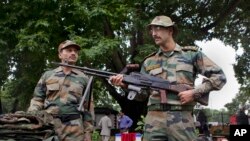 Indian army soldiers display seized arms and ammunition at the army headquarters in Srinagar, India, August 16, 2013. 