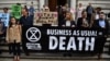 Climate change activists stage a protest outside the H M Treasury building in central London, April 25, 2019, during environmental protests by the Extinction Rebellion group.
