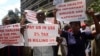 FILE: Teachers hold banners during a protest against the high cost of living, in Zimbabwe's capital Harare on Nov. 9, 2018.